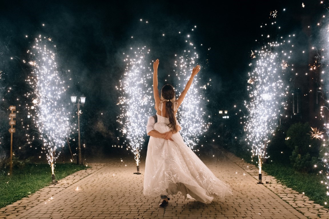 Beautiful,Happy,Young,Wedding,Couple,Dancing,Outdoor,Between,Fireworks